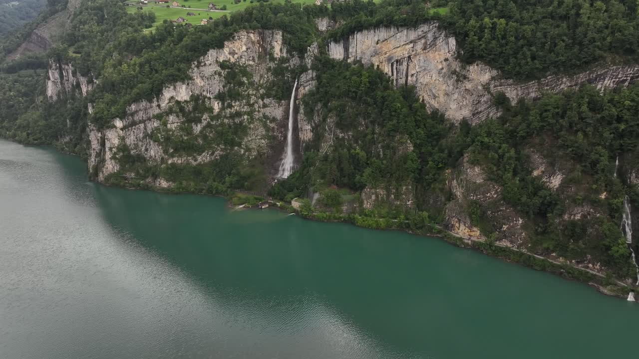 Waterfall cascading down cliffs into a serene lake