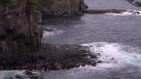 Ocean-Waves-Breaking-And-Splashing-On-The-Volcanic-Rocks-Against-The-Cliffs---static-shot