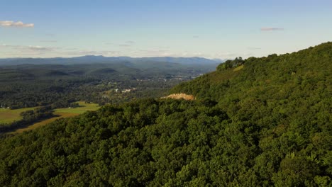 Aerial-drone-footage-of-a-beautiful-scenic-highway-in-the-Appalachian-mountains-during-late-summer-or-early-autumn-at-sunset