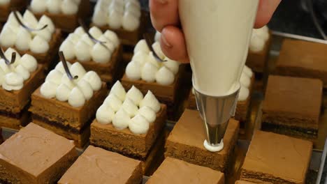 making miniature chocolate cakes with whipped cream