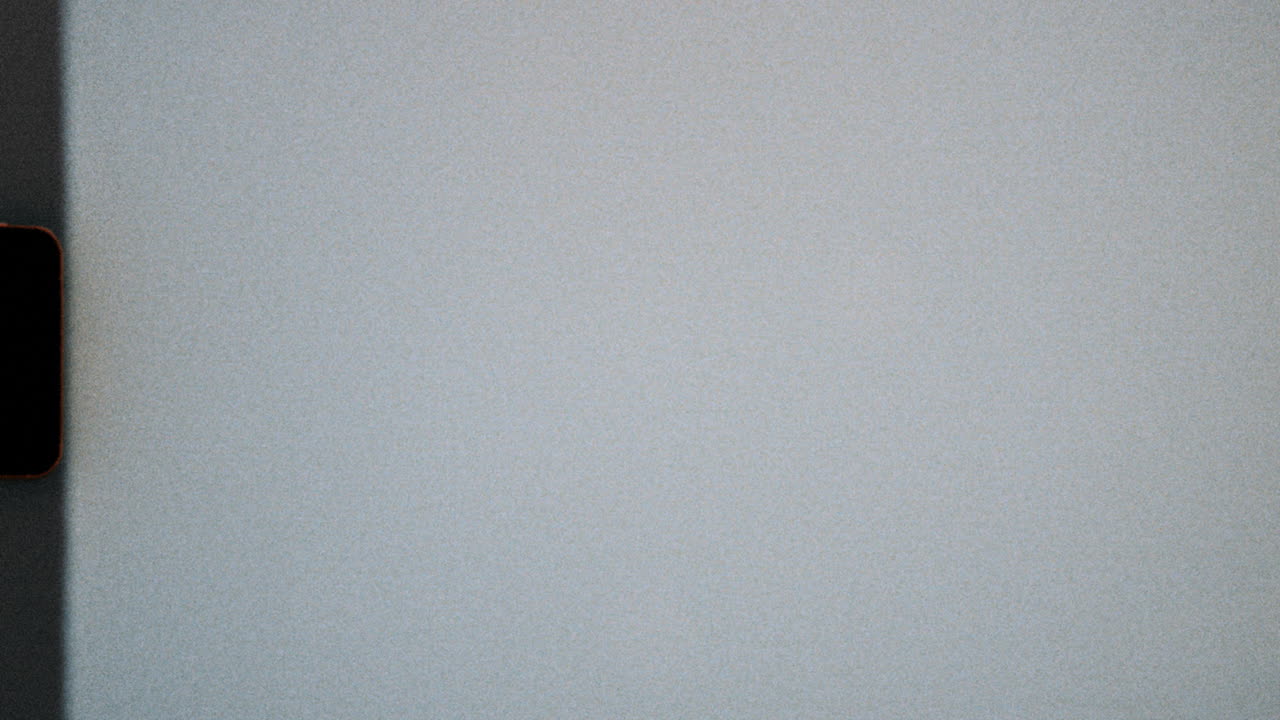 Blank super 8mm film frame with subtle grain and analog gate