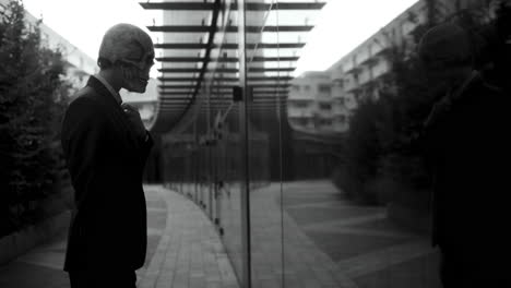 man in skull mask reflecting in cityscape
