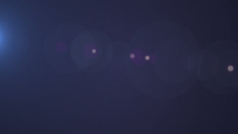 animation of moving spots of lights over black background