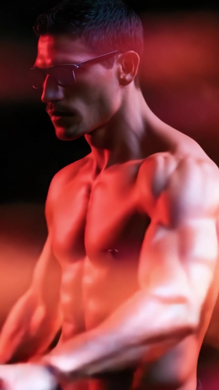 Striking Portrait of a Muscular Male Model Exuding Confidence and Power Amidst Ethereal Smoke Effects