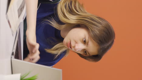 vertical video of young woman working hard on laptop.