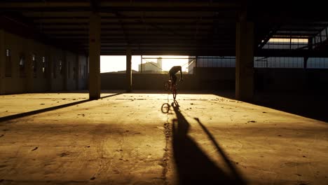 bmx rider in an empty warehouse
