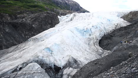 glacier surrounded by black rock in alaska