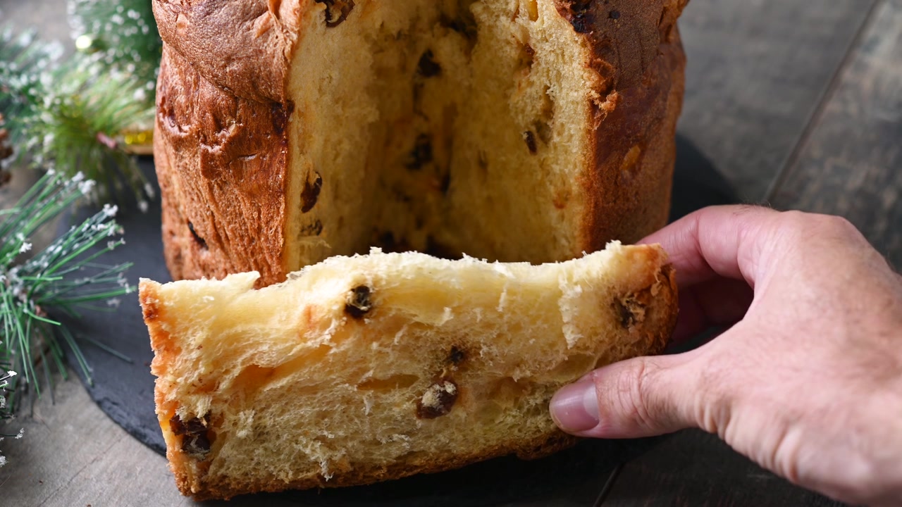 Cutting traditional Italian Panettone for christmas