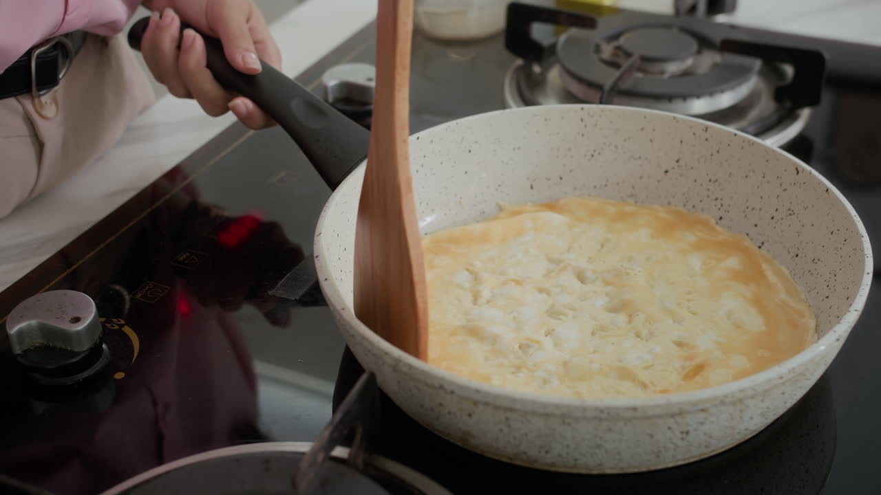 Hands of Girl Cooking Omelet on Pan at Home