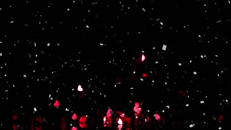 animación de corazones rojos que caen y confeti sobre fondo negro