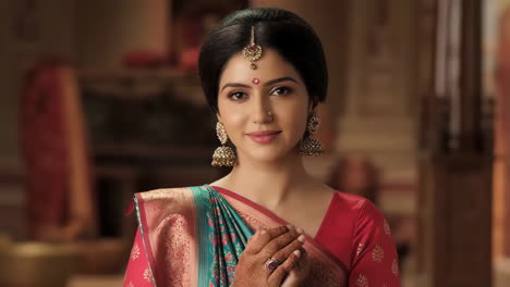 portrait of a woman wearing a sari and traditional jewelry