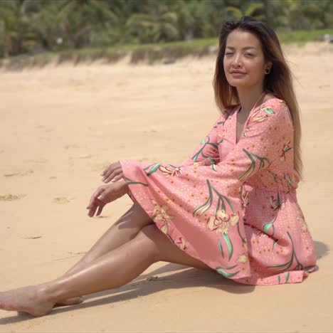 Barefoot-woman-sitting-on-beach