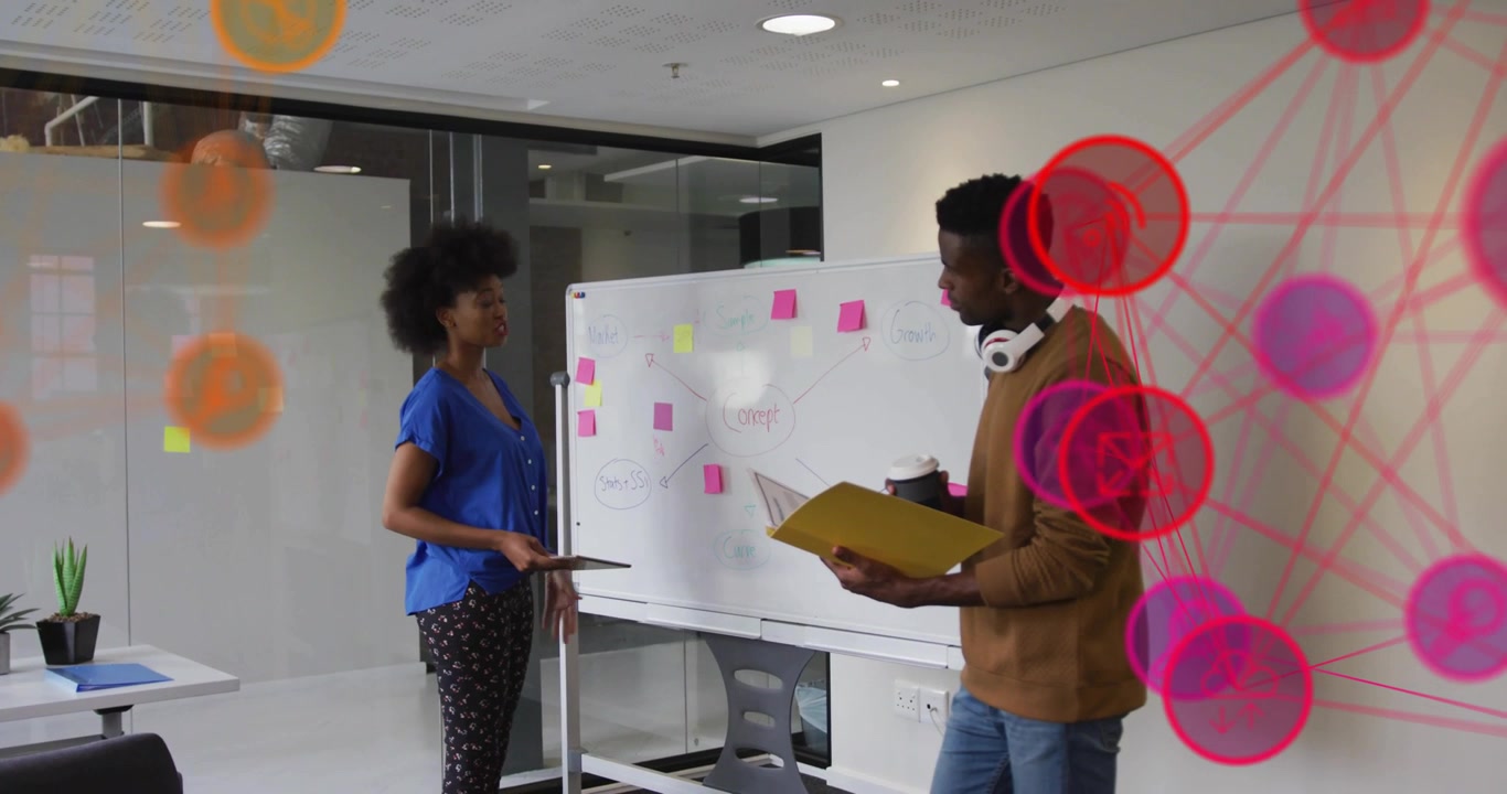 Woman peeling pink sticky note causing node overlay with peer arranging mind-map in business office