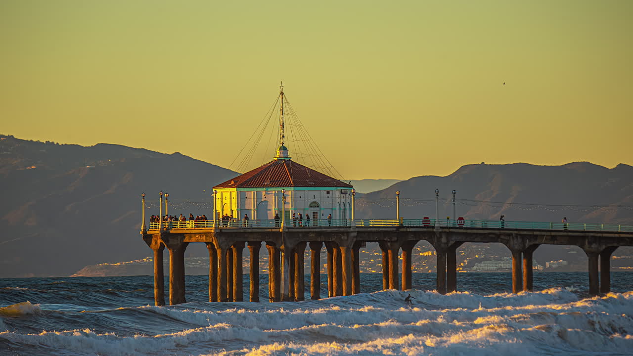 Time Lapse, Golden Hour Sunlight and Sunset on Roundhouse Aquarium and Pier on Manhattan Beach, Los Angeles CA USA