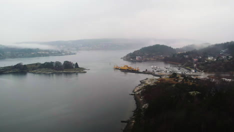 Aerial-of-Ferry-at-Shore-a-Foggy-Day,-Orust,-Sweden