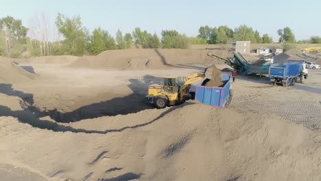 heavy equipment loading sand and gravel