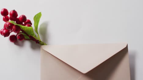 video of christmas decorations red berry with envelope on white background