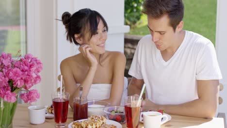 couple having breakfast at outdoor table