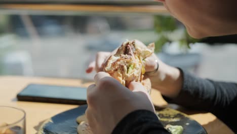 persona comiendo un sándwich