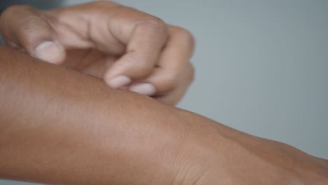 a person scratching their arm