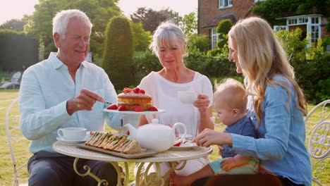 Grandparents-Have-Afternoon-Tea-With-Grandson-And-Adult-Daughter