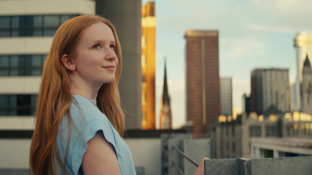 Woman on a rooftop overlooking the city