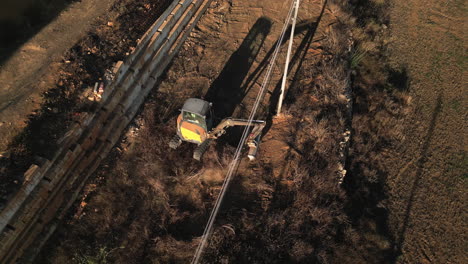 aerial shot of an excavator landscaping in sunset