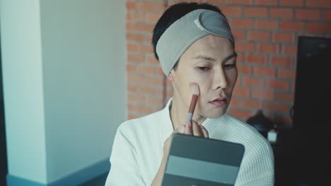 man applying makeup