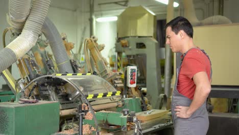 man operating a woodworking machine in a workshop