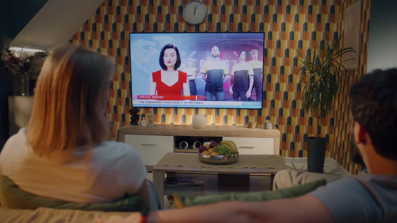 People watching a news report on a TV in a retro living room