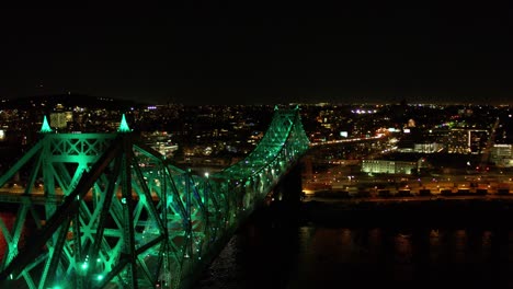 drone moving around the jacques-cartier bridge in montreal revaling the city in background