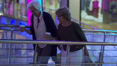 elderly women drinking takeaway coffee