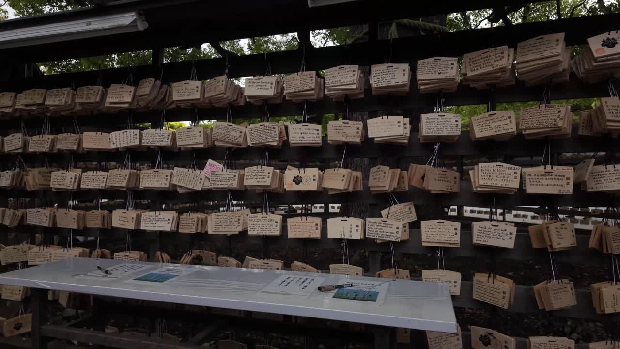 Ema wood plaques collection Shinto used for writing prayers wishes Meiji Shrine Tokyo Japan
