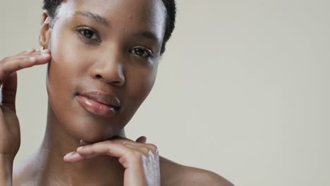 Happy-african-american-woman-with-short-dark-hair-on-grey-background-with-copy-space,-slow-motion