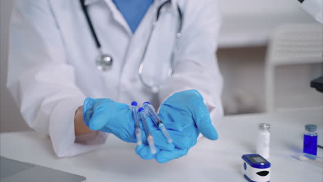 doctor holding syringes