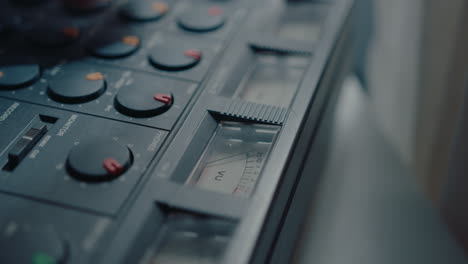 close-up view of using vintage multitrack cassette recorder at music studio