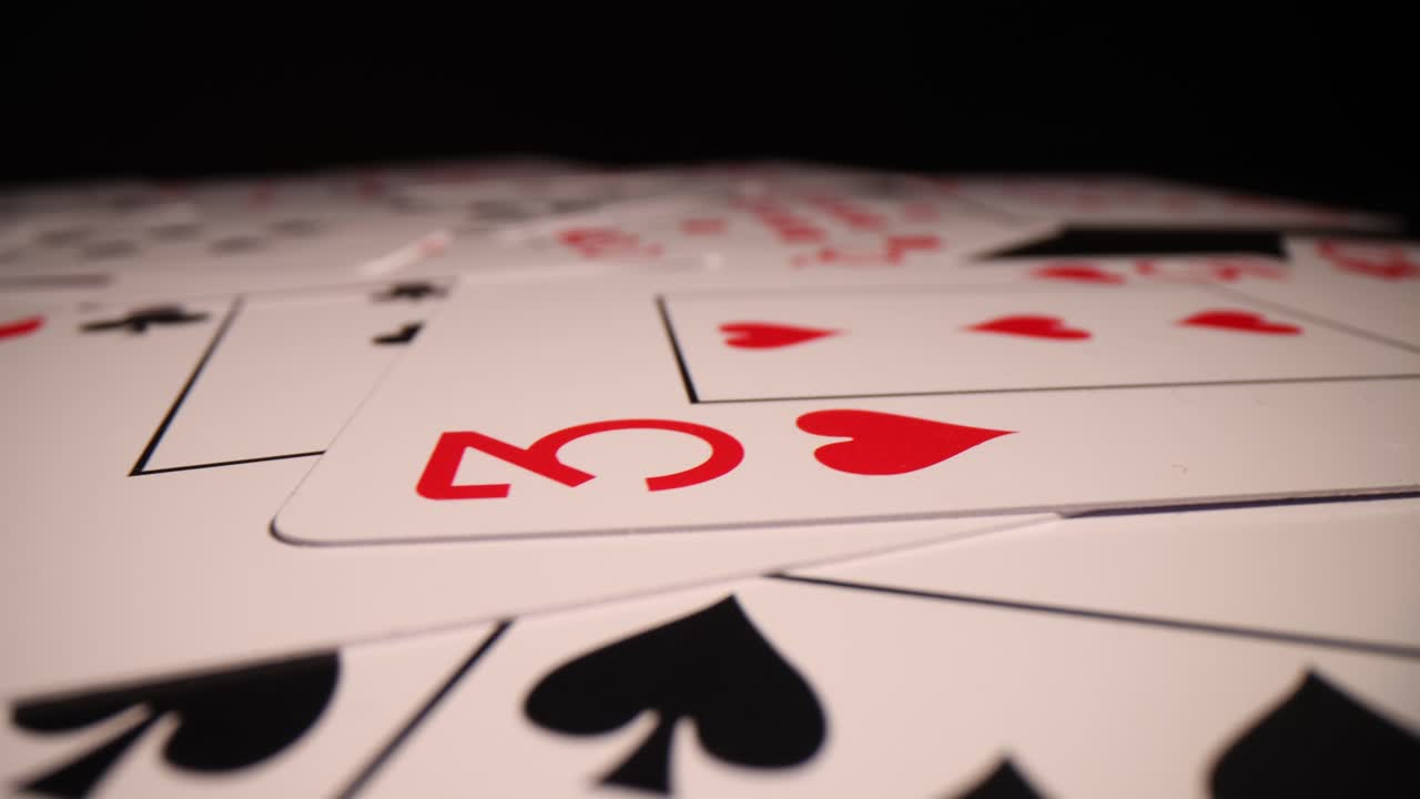Close-up of Scattered Playing Cards on a Dark Surface