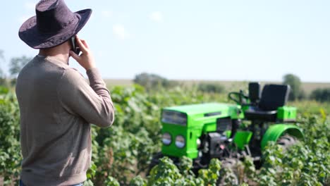 a modern farmer or winemaker talks on a smartphone during the harvest season in the vineyard a modern farmer or winemaker talks on a smartphone during the harvest season in the vineyard vineyards on plantations in france rural worker