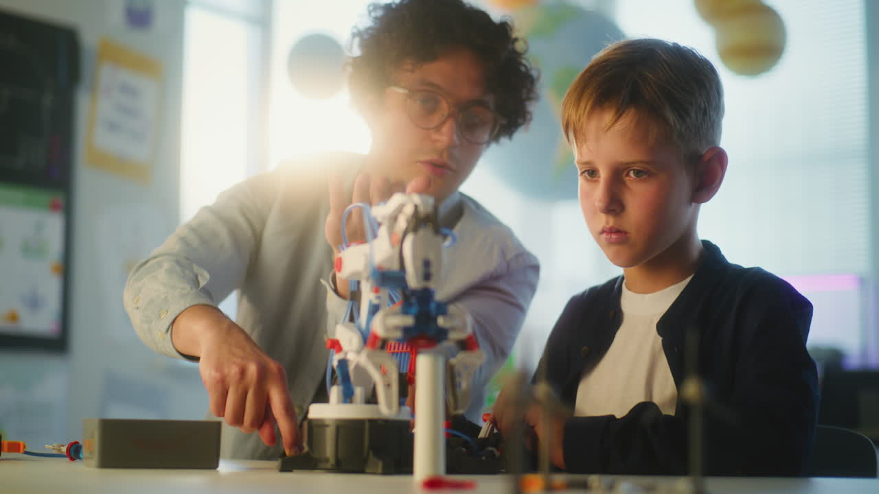 Teacher and Student Working on a Robot Model