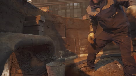 industrial worker repairing furnace