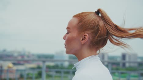 redhead woman running in city