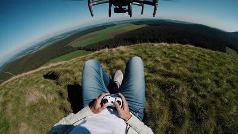 drone pilot relaxing on a hilltop