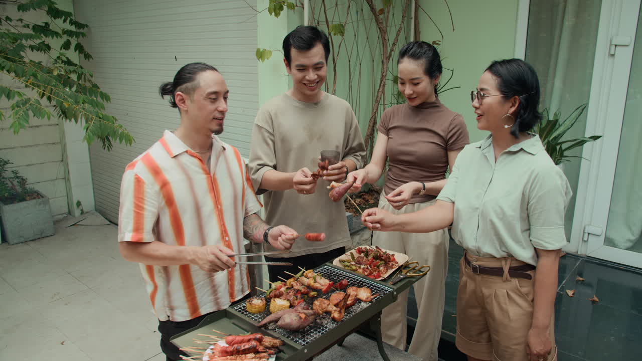 Portrait of Four Friends Barbecuing at Weekend