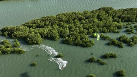 kitesurfer with incredible skills maneuvers between mangroves at barra grande