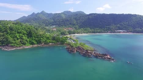 idyllic koh chang island aerial pull back view across turquoise coastal ocean bay resort