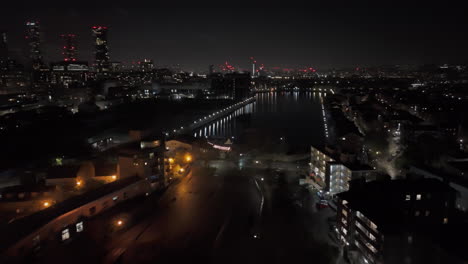 aerial view toward the millwall outer dock, night in isle of dogs, london, uk