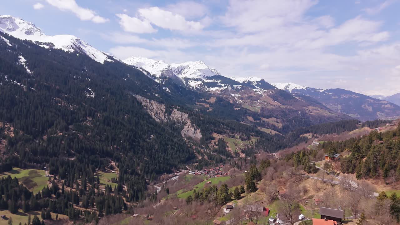 Snow-capped mountains and green valley in peist, switzerland, aerial view