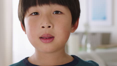 portrait happy little asian boy sticking out tongue naughty child having fun playfully making faces 4k footage