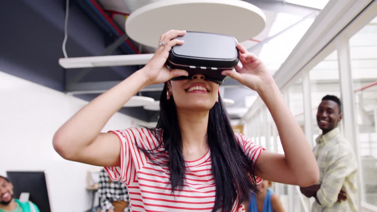 Female creative using VR goggles in a modern office