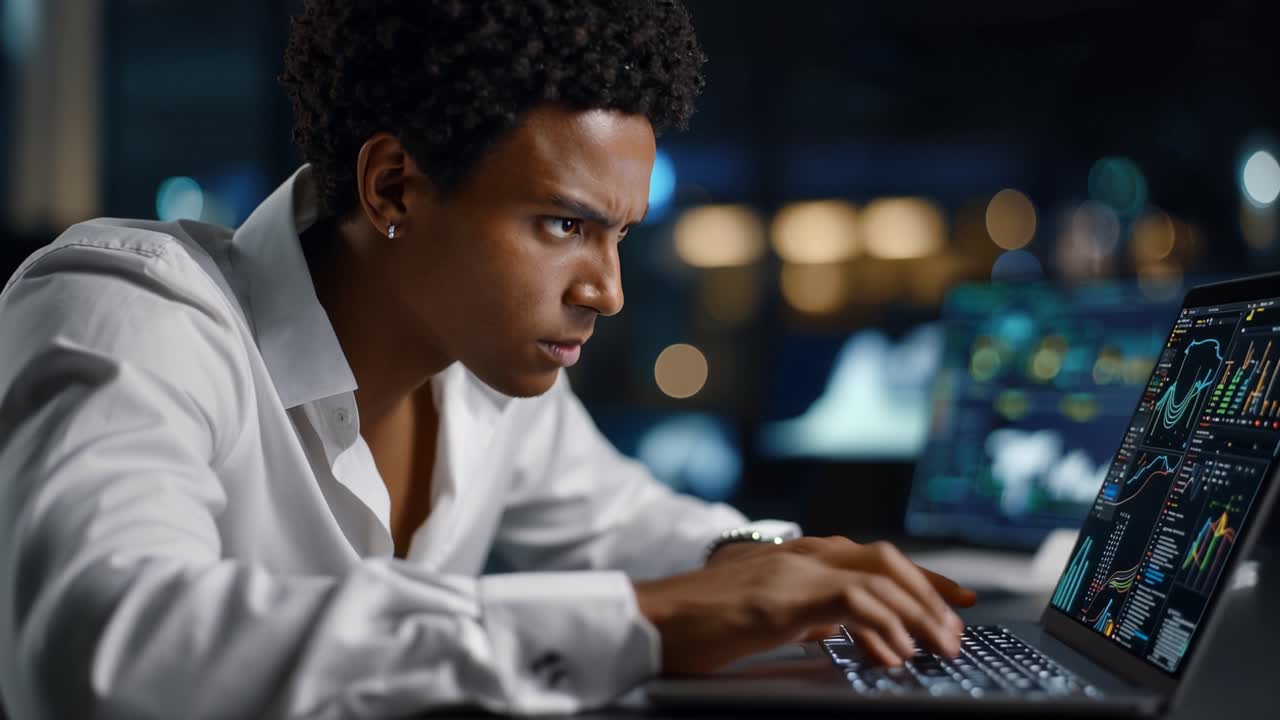 Focused Professional Analyzing Data on Laptop in Modern Office Environment, Concentrating on Analytics and Insights from Multiple Screens with Graphs
